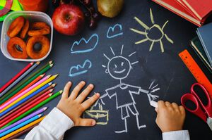 childrens hands writing on a blackboard. school concept. the toning. selective focus